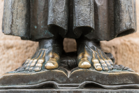 Detail of the bare feet of the sculpture of San Pedro de Alcantara in the cathedral of Santa Maria in the old town of Caceres.のeditorial素材