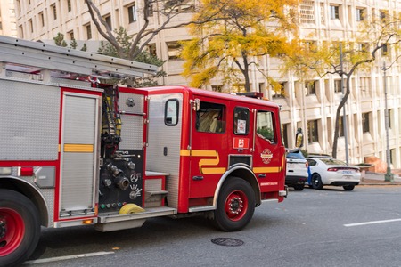 A fire truck passes very fast on a street in Seattle, Washington, USA.