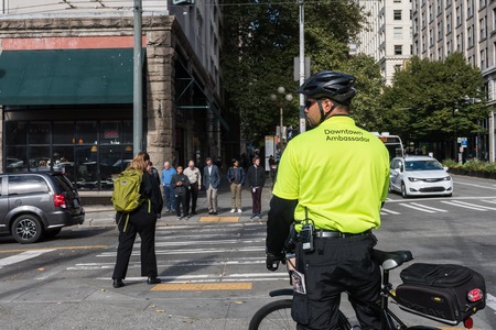 Downtown Ambassador with his characteristic yellow shirt and bicycle in Seattle, Washington, USA.