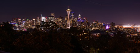 Panoramic night view of the Seattle skyline with the Space Needle and other iconic buildings in the background.の写真素材