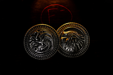Metal medals inspired by the Stark house shields and Targaryen from the TV series Game of Thrones for sale as amulets.のeditorial素材