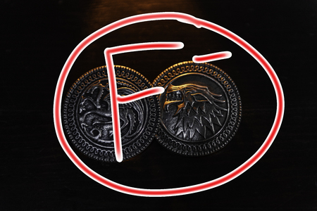 Metal medals inspired by the Stark house shields and Targaryen from the TV series Game of Thrones for sale as amulets.のeditorial素材