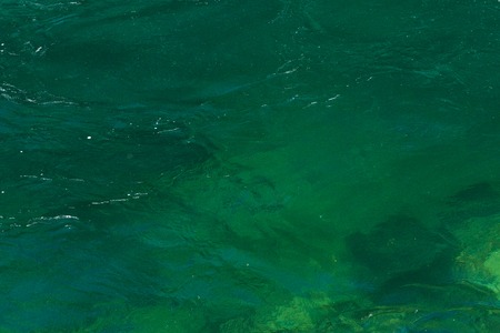 Detail of the turquoise water of the Skagit River and the rocks under itの写真素材