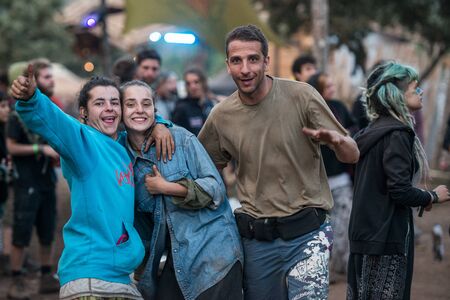 A couple and a man looking to the camera in the main stage of the Lost Theory psytransce music...