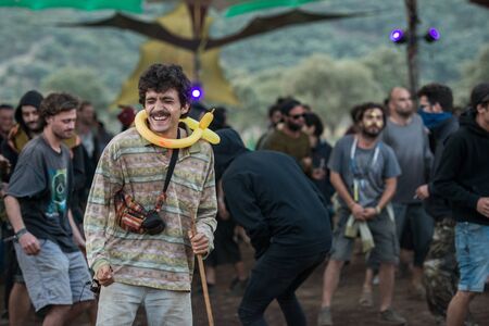A man with a yellow ballon on his neck dance at the main stage of the Lost Theory psytransce music festivalのeditorial素材