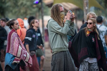Man takes photographs with his smartphone and a woman with a pacifier on the main stage of the Lost Theory festivalのeditorial素材