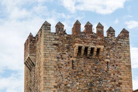 A tourist in the Tower of Bujaco seen from the Plaza Mayor de Caceres, Extremadura, Spainのeditorial素材