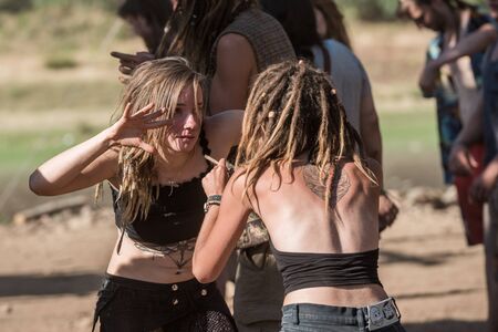 Two young women dance face to face on the main stage at the psytrance Lost Theory festival in Riomalo de Abajoのeditorial素材