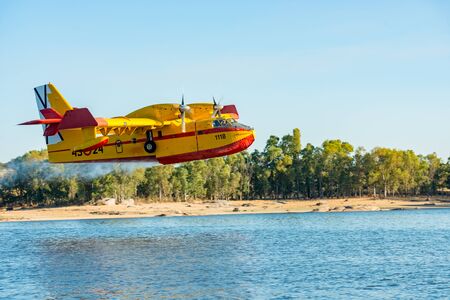 Hydroplane of the Spanish army loading water from the Salor reservoir due to a fire declared near Caceresのeditorial素材