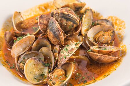 Detail of a dish of clams in red sauceの写真素材