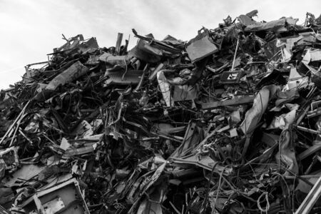 A huge mountain of metal pieces of different origin accumulated in a scrap yard near Sierra de...