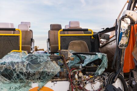 Detail of a crashed bus with no roof and broken front glass.の写真素材