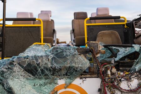 Detail of a crashed bus with no roof and broken front glass.の写真素材