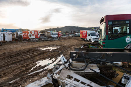 Delivery trucks and an abandoned bus in a junkyard near Sierra de Fuentes, Extremadura, Spainのeditorial素材