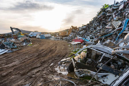 Sunset views of cranes working in a scrap yard near Sierra de Fuentes, Extremadura, Spain.のeditorial素材