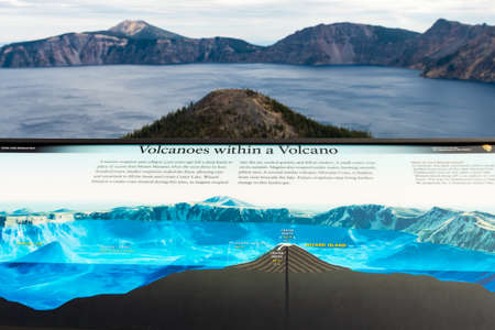 View of an explanatory panel of the volcano inside the volcano and a view of Crater Lake behind