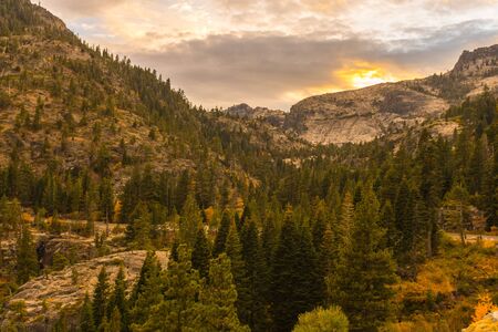 Detail of the sunset sky over the rocky mountain and the pines next to Emerald Bay in Lake Tahoe, California, USAの写真素材