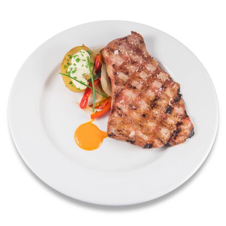 Dish of grilled Iberian pork secreto with baked potatoesの写真素材
