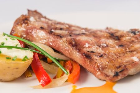Dish of grilled Iberian pork secreto with baked potatoesの写真素材
