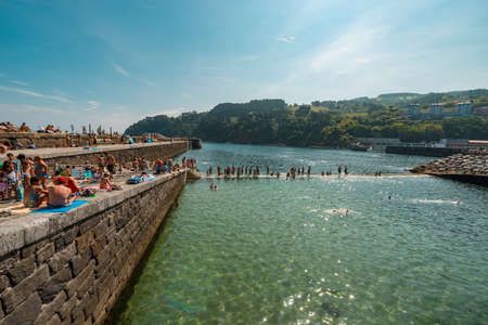A large group of people bathing near the port of Mutrikuのeditorial素材