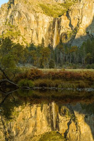 The Bridalveil Fall and its reflection in the Merced River at sunset in Yosemite National Park, California, USA.の写真素材