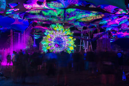 People dancing at night on the stage of the festival Psytrance Lost Theory in Rio Malo de Abajo in Las Hurdesのeditorial素材