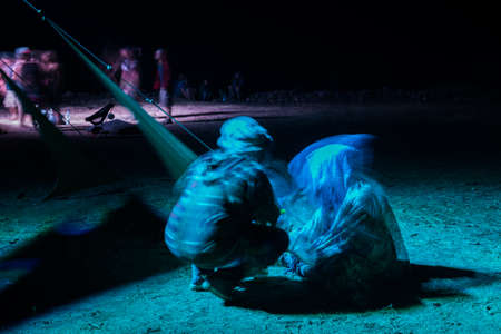 Two guys with hoods sitting on the floor of the stage of the festival Psytrance Lost Theory in Rio Malo de Abajoのeditorial素材