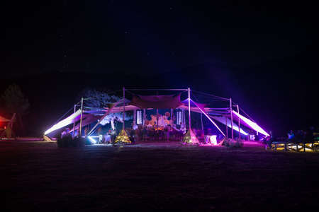 People dancing at night on the stage of the festival Psytrance Lost Theory in Rio Malo de Abajo in Las Hurdesのeditorial素材