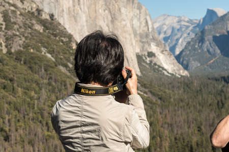 A man takes pictures with his Nikon camera at the Tunnel View point in Yosemite National Parkのeditorial素材