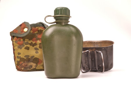 flask plastic army green not new from the front, separate cover from it and a cauldron of the furnace in a standing position, on a white background.の写真素材