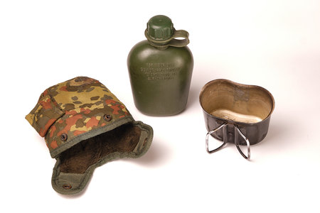 the army green plastic flask is not new, and the cover from it in a lying position and the flask from the flask are separate on a white background.の写真素材