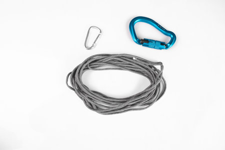 paracord gray tactical for survival untied assembled on white background with carabiners large blue and small silverの写真素材