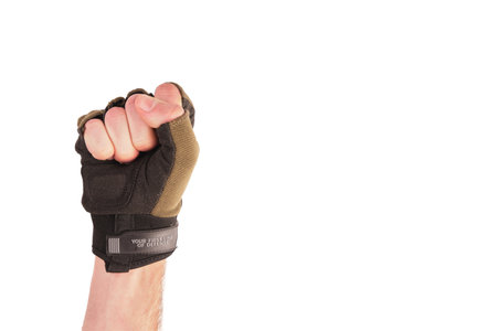 tactical military glove without fingers olive for hand protection. Dressed on the arm. The fingers are folded into a fistの写真素材