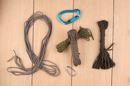 cord strong paracord tactical, tourist 550, on wood-tile. Carbines