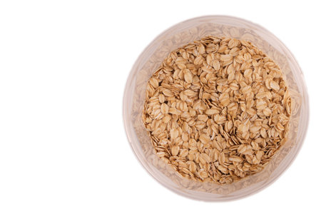 oat groats in plastic jars isolate, top view with reflection on the wallsの写真素材