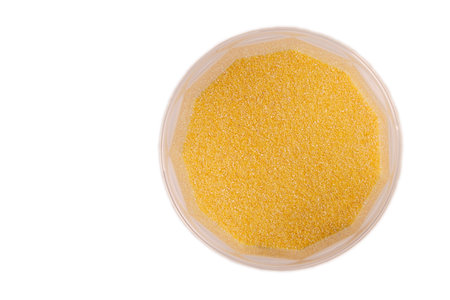 corn grits in plastic jars isolate, top view with reflectionの写真素材