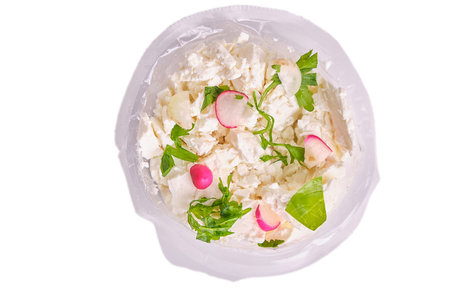 Vegetable salad from the garden. Watercress salad and white and red radish cut in a plastic plate, white cheese and sour cream, isolate, fresh, natural, top viewの写真素材