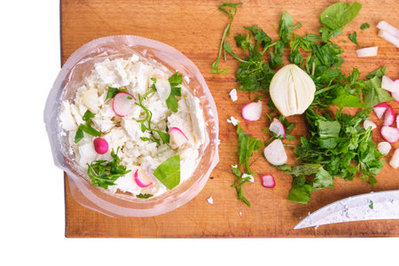 watercress salad and radish, white cheese, onion cut with a knife on a wooden board isolate, fresh, naturalの写真素材