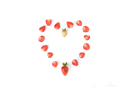 strawberry berries heart in section isolate. Mature, natural. Green and red with whole leavesの写真素材