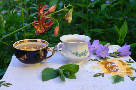 mint tea outdoors in mugs, lilia flowersの写真素材
