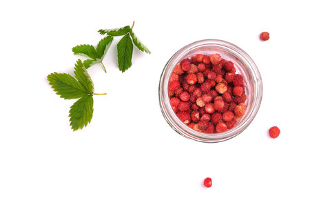 Fragaria berries, wild strawberry in a jar isolated on white top view, wild strawberry leavesの写真素材