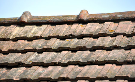 On the roof of the house is an old red ceramic tileの写真素材