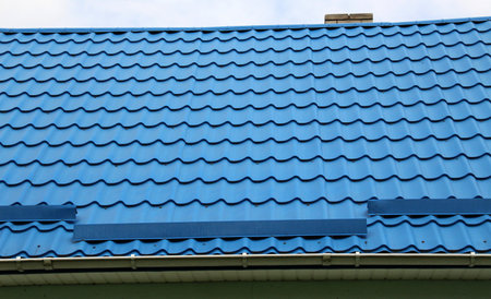 The house, the roof of which is covered with metal tilesの写真素材