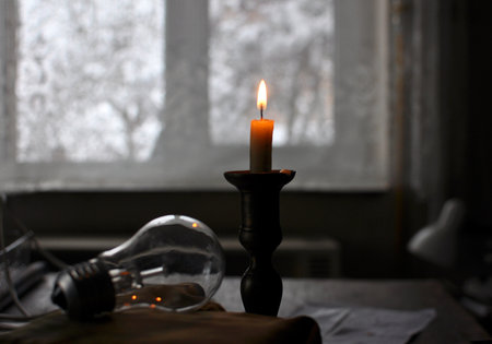 In the dark, when there is no electricity supply, a candle is litの写真素材