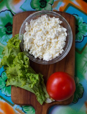 lettuce , cheese, tomato on wooden boardの写真素材