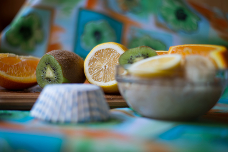 oatmeal, orange, banana, kiwi on wooden boardの写真素材