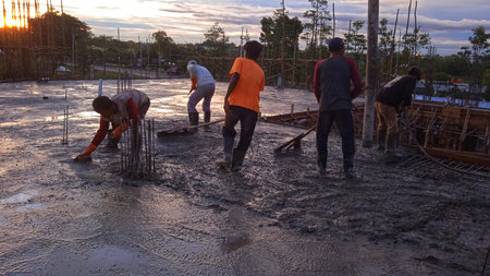 Silhouettes of workers on a construction site, during the hot sun during the day