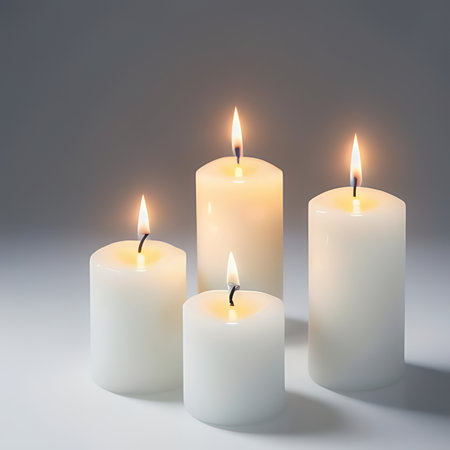 Three burning candles on a grey background. 3d rendering, toned imageの素材