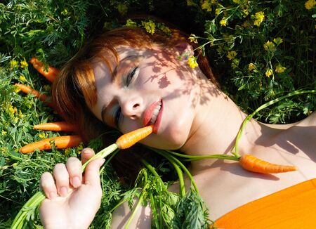 Beautiful girl with tasty carrotの写真素材