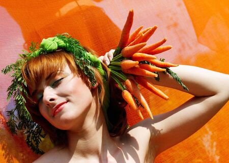 Woman holding bunch of carrotsの写真素材